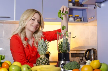 junge Frau befüllt einen Smoothie Maker